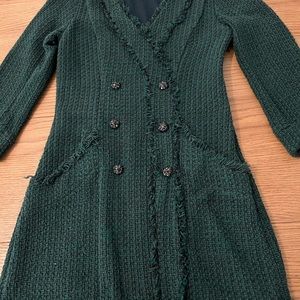 A tweed dark green dress with elegant buttons